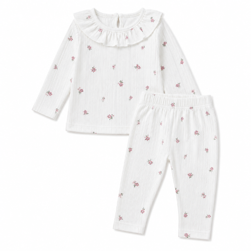 bialy-komplet-dziewczecy-w-kwiaty-bluzka-z-falbanka-i-legginsy.webp