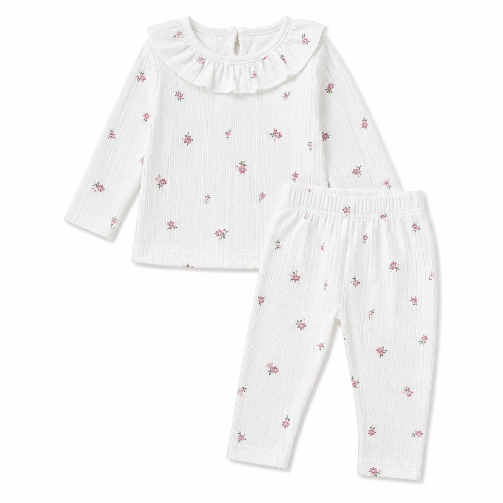 bialy-komplet-dziewczecy-w-kwiaty-bluzka-z-falbanka-i-legginsy.webp